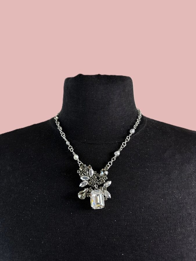 CHRISTIAN DIOR by JOHN GALLIANO Necklace in white gold-patinated metal with smoky and translucent rhinestones—signed and featuring a monogram charm on the clasp—with pouch and bag 
Length: 42 cm