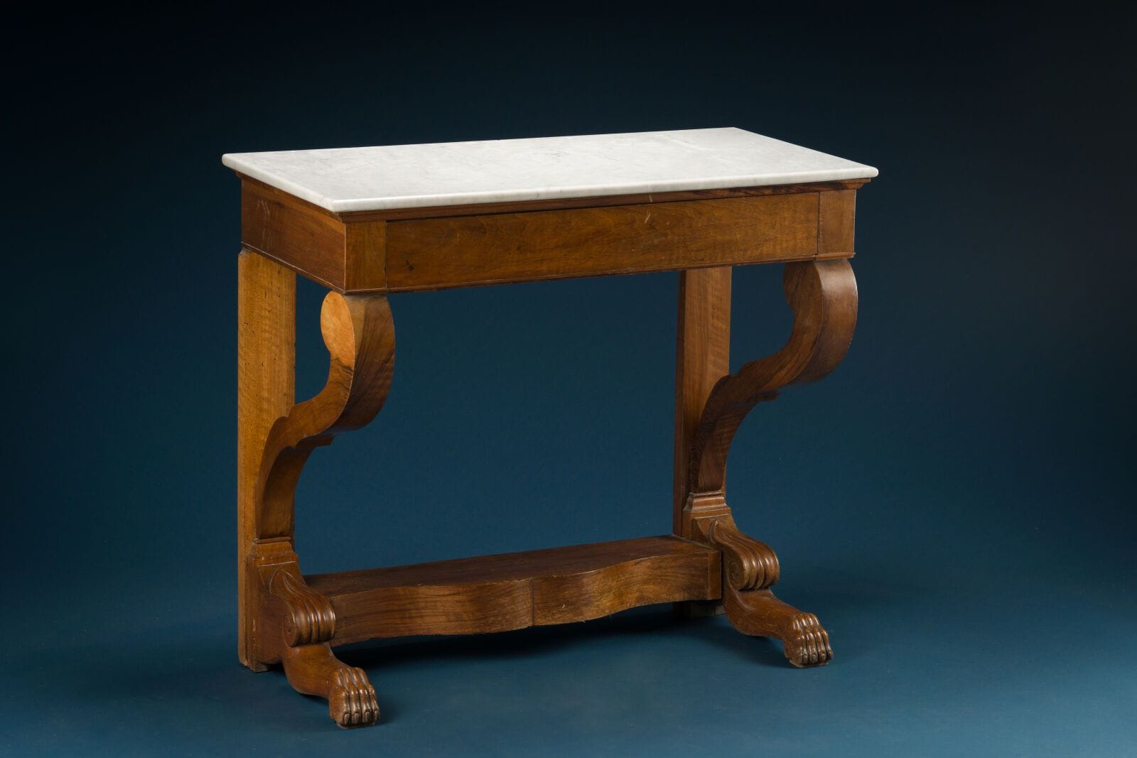 Mahogany console table with a single drawer set into the side panel, console-style legs joined by a crossbar, white marble top, 19th century
The legs are finished with claw feet. 
H.: 89 cm; W.: 99 cm; D.: 50 cm.
(Stripes).
