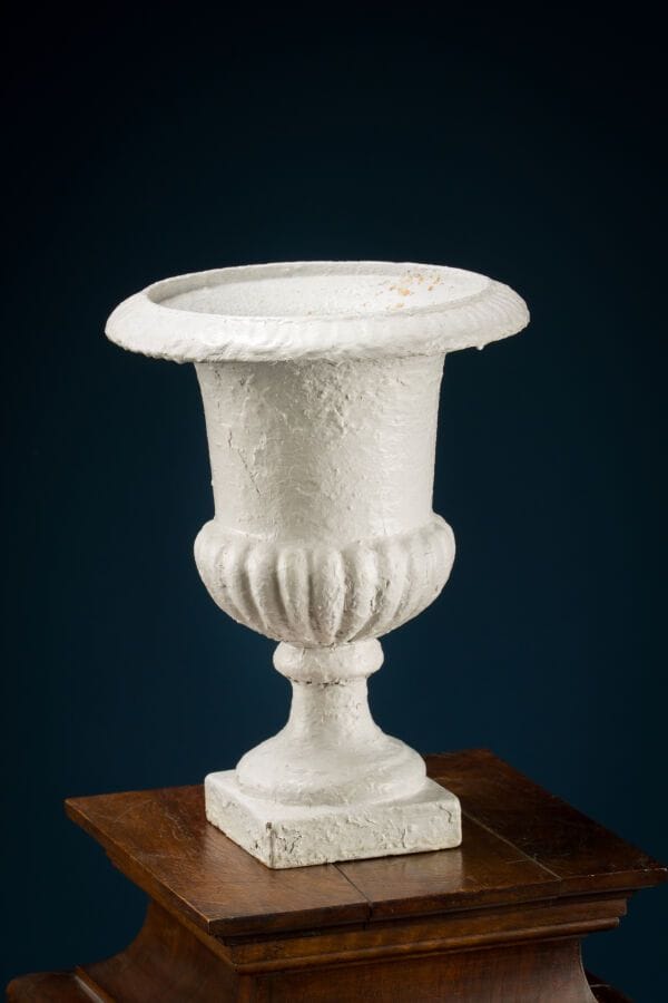Medici vase made of cast iron, with a white glaze. 
Height: 34 cm.