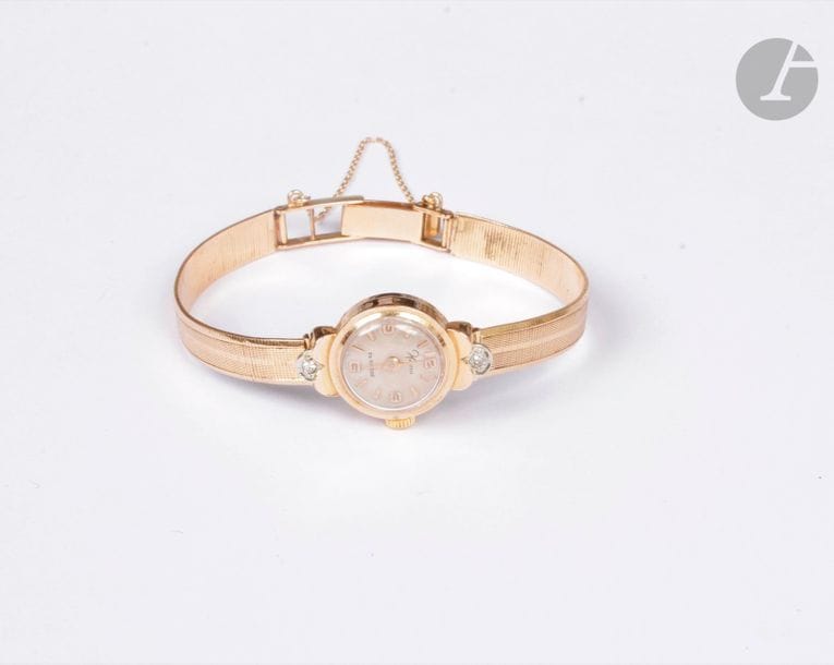 Montre de dame en or 18K (750), cadran rond, bracelet souple en or 18K. Poids brut : 20,1 g