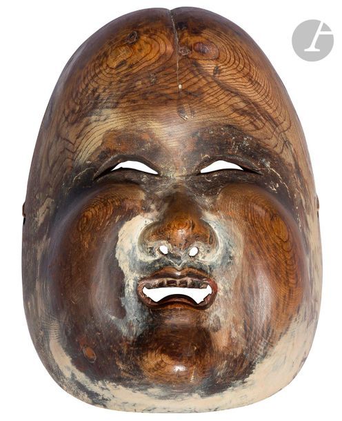 JAPON - XIXe siècle
Masque d’Okame en bois de cyprès dit « hinoki » à traces de polychromie. (Gerces, usures). 
H. 21 cm