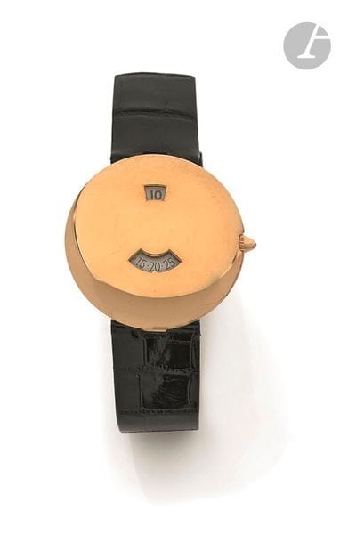 CHAUMET Les Pleiades heure sautante. Vers 1990
N° 10A-627
Montre bracelet pour homme en or jaune 18K (750), cadran rond en or en forme de galet à guichet heures et minutes, mouvement mécanique à remontage automatique, bracelet cuir avec sa boucle ardillon en or jaune 18K signée.
Cadran, boîtier et mouvement signés.
La montre est accompagnée de son écrin.
Diamètre : 35 mm
Poids brut : 44,6 g
