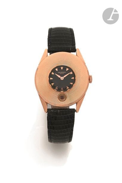 UNIVERSAL Genève . Vers 1960
N° 1799697-1001101
Montre bracelet pour homme en or rose 18K (750), cadran noir, index appliqués formant les heures, date par guichet à 6h, mouvement mécanique à remontage automatique calibre 138C, bracelet cuir boucle ardillon non signée en métal doré.
Cadran, boîtier et mouvement signés.
Diamètre : 35 mm
Poids brut : 46,9 g