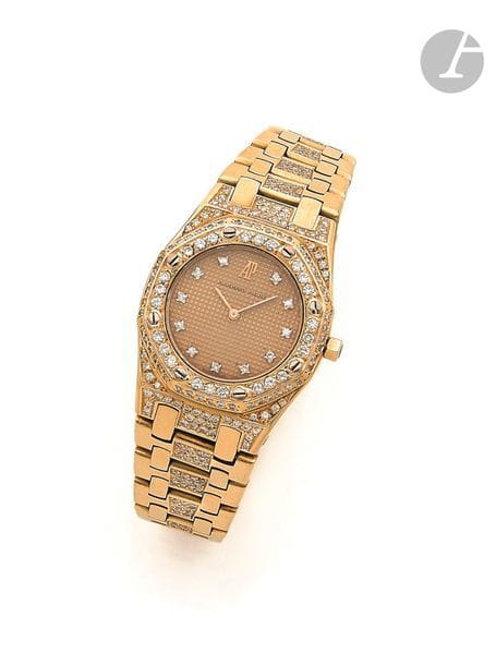 AUDEMARS PIGUET. Vers 1990
N° 1538
Montre bracelet pour femme en or jaune 18K (750), lunette sertie de diamants taille brillant, cadran doré index diamants formant les heures, mouvement à quartz (fonctionne), bracelet en or jaune 18K partiellement serti de diamants taille brillant avec sa boucle déployante signée.
Cadran, boîtier et mouvement signés.
Diamètre : 26 mm
Poids brut : 93,8 g