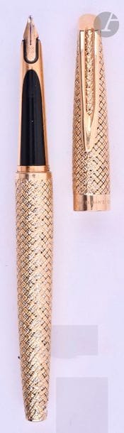 HERMèS
Stylo plume en or 18 carats décor tressé 2 ors. Réalisé par le joaillier parisien Lefebvre, sur une base de Waterman CF. Plume or 18 carats (attributs plaqués or sur le bloc plume), remplissage convertor. Petits coups et micro-rayures. 
Longueur : 134 mm - Poids brut : 38 g
