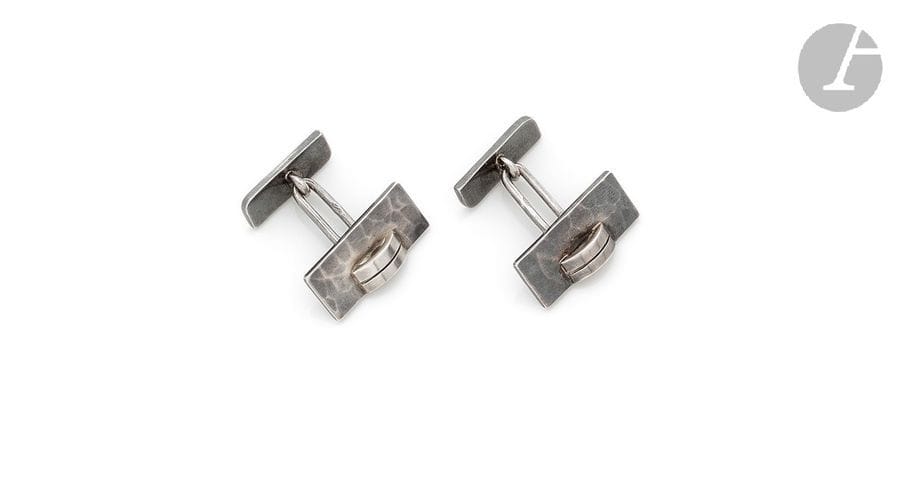 JEAN DESPRÉS (1889-1980)
Rare paire de boutons de manchette modernistes en argent. Les platines traitées lisses au motif d’une double barrette en décrochement et en application sur un fond rectangulaire martelé. Chaque bouton signé J. DESPRÉS à la pointe et porte les poinçons de Maître Orfèvre et de garantie. Poids : 19,7 g

Provenance :
- M. et Mme X., Avallon. Œuvre acquise directement auprès de Jean Després.
- Mme D., Sarzeau (Bretagne). Fille des précédents.