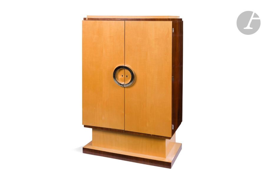 TRAVAIL DES ANNÉES 1930
Cabinet formant meuble de salon en placage de bois clair et de palissandre. La façade ouvre par deux portes pleines ; les prises semi-circulaires en métal chromé possiblement rapportées. Base socle. Intérieur muni de 4 étagères. Restaurations, sauts de placage, rayures, petits chocs. H. 133 cm – L. 80 cm – P. 40 cm