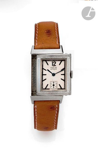 The CULT. Circa 1940N
 24558Men's wr
istwatch with
 Reverso type steel bracelet, beige Uniplan dial, applied baton hour markers forming the hours, second hand at 6 o'clock, mechanical winding movement, case engraved with CG initials, leather strap with unsigned steel pin buckle
.

 Dial, case and movement signed

.

 Diameter: 23 mm x 38 mm

