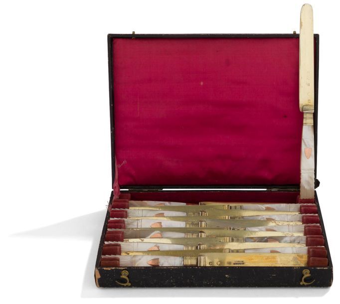 NAMUR (BELGIQUE)

Suite de douze couteaux à dessert en vermeil dans un écrin, l'extrémité des manches en nacre sculptée d'un décor en éventail et rehaussée d'un écusson en vermeil non gravé, les lames à bout arrondi portant le nom du fabricant : ARNOULT à NAMUR. Parfait état

FRANCE, 1809 - 1819

Poinçon de moyenne garantie (tête casquée) de Paris

Poids brut : 377,20 g - longueur : 18,9 cm