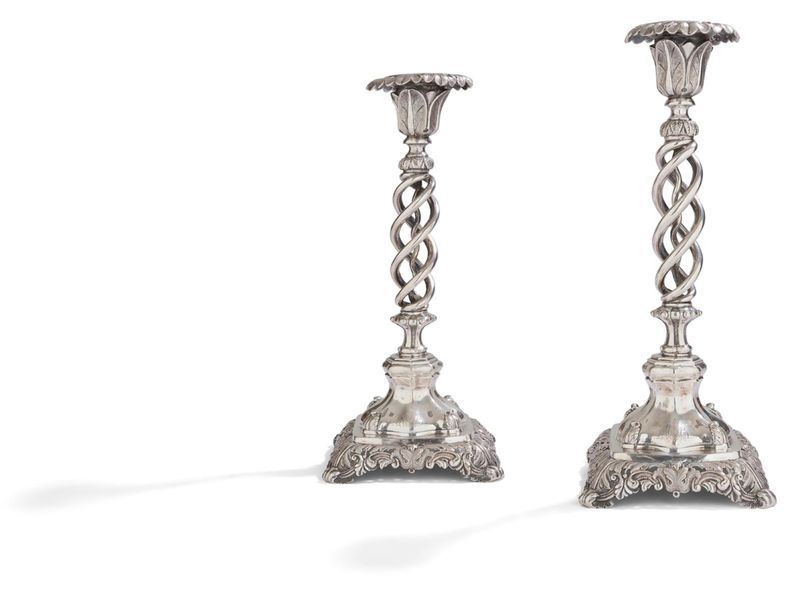 PORT 1761 - 1770

Pair of silver candleholders with hollowed out double helix shaft and its coils. They rest on a square base with openwork foliage on the shaft and the edge of the bobèches.

AAL tester's stamp

Weight: 1105.90 g - height: 27 cm