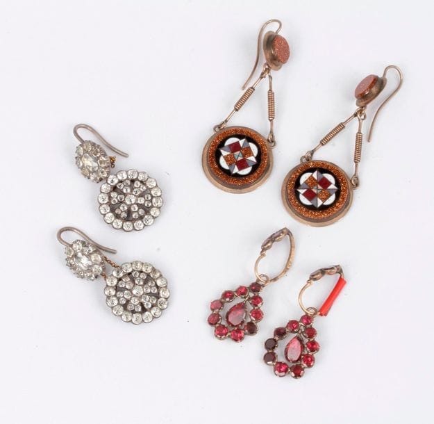 Suite de 3 paires de pendants d’oreilles en métal : la 1ère ornée d’une mosaïque de pierres ornementales et d’émaux sur fond de verre aventuriné, la 2e agrémentée de pâtes de verres rouge sur paillon, la 3e agrémentée de strass incolores. Travail du XIXe siècle (accident, égrisures)