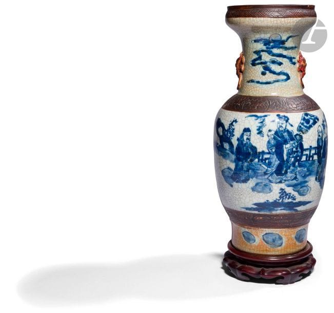 CHINA, Nanking - 19th
centuryCracked porcelain and stoneware
vase
with blue underglaze decoration on the neck and on the belly and feet, decorated with dignitaries on a terrace, two handles in the shape of chimera heads on either side of the neck. Mounted as a lamp, pierced bottom
.
 
H. 45.3 cm; wooden base.

