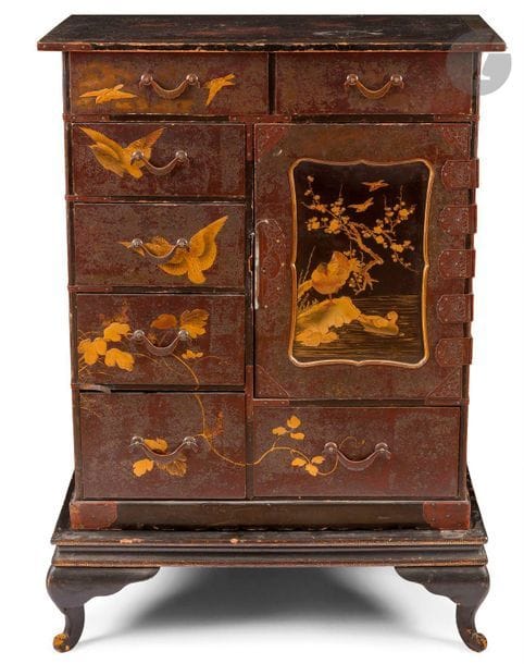 JAPON - Époque MEIJI (1868 - 1912)
Cabinet en bois laqué brun, ouvrant en façade par deux tiroirs en partie supérieure, quatre tiroirs sur la façade gauche, la porte ouvrant sur trois tiroirs. (Accidents, éclats). 
95 x 37,5 x 67 cm