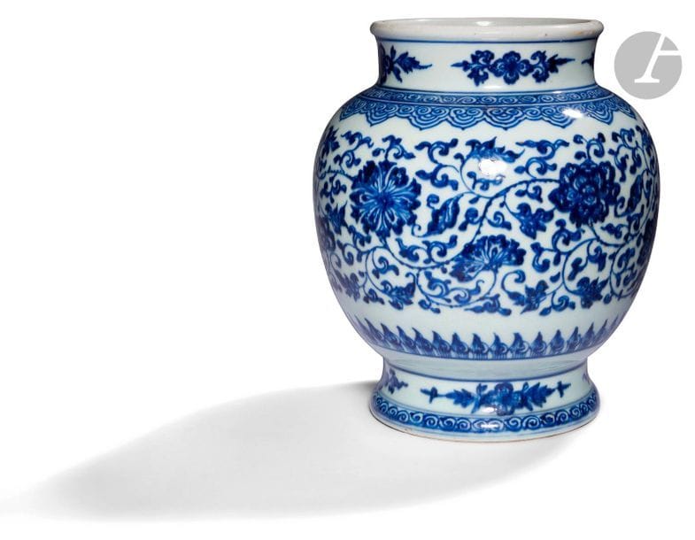CHINE - Époque QING (1644 - 1911)
Vase en porcelaine blanche émaillée en bleu sous couverte à décor de fleurs dans leurs rinceaux mouvementés, l’épaulement et le pied ornés de frises de spirales. (Étoiles à l’intérieur du vase). 
H. 20,1 cm