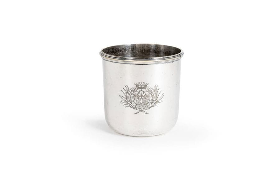FRANCE XIXth CENTURY 
Silvered metal glass cooler of circular shape bordered with nets, engraved with a wedding band coat of arms surmounted by a count's crown.
Height : 13,5 cm

