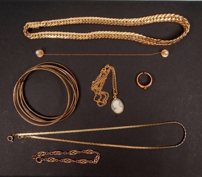 Lot de bijoux en or (18K). Poids brut : 32,5g.
Un collier en or tressé, une paire de boutons en or et perles.

On joint : un bracelet chaine de montre et un collier maillons plats en métal doré ainsi que des bijoux en métal (7 bracelets rigides, une bague, un pendentif et sa chaine).