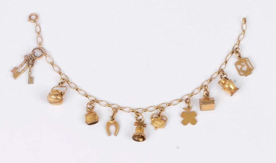 Bracelet en or (18K) et douze breloques en métal.
Poids brut : 10,4 g