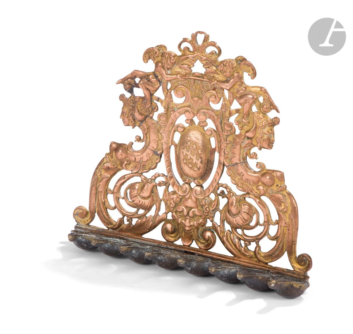 LAMP OF HANOUCCA 
Italy, 17th century for the back part, the ramp of buckets is posterior. 
Fused bronze, openwork and bearing traces of gilding. 
The back plate is decorated with two grotesque female forms, cherubs, foliage and scrolls flanking a cartouche bearing a coat of arms. 
(Restorations). 
19,5 x 22 cm The 

inventiveness of the Hanukkah lamp makers knows no limits

. 

So much so that they recovered decorative elements intended for the clergy and reused them to make lamps. This explains why we find on the back of these lamps, the presence of ecclesiastical coats of arms and a decoration with a flat hat of a bishop held by two cherubs. Hanukkah lamps made from elements of the 17th century are rare. This model is very close to the Hanukkah lamp owned by the Victoria and Albert Museum under the reference M.418-1956. It differs from it, however, in its coat of arms. It is also very close to the copy sold at Ader Nordmann on March 22nd 2017 (lot n° 121).

Bibliographie : 
KEEN Michael, Jewish Ritual Art in the Victoria and Albert Museum, London, 1991
. 


Keywords :
judaica, jewish, jewish, rabbis, jewish, torah, hebrew, hebraica, judaism, synagogue, zionism, pessah, pessach, haggada, haggadah, hagada, hagadah, passover, menora, menorah, hannuka, hannuca, hannucca, hannuccah, torah, juden, israelite, israelite, israel, antisemitism, antisemitism, dreyfus, meguila, sepharad, sefarad, ketubah













