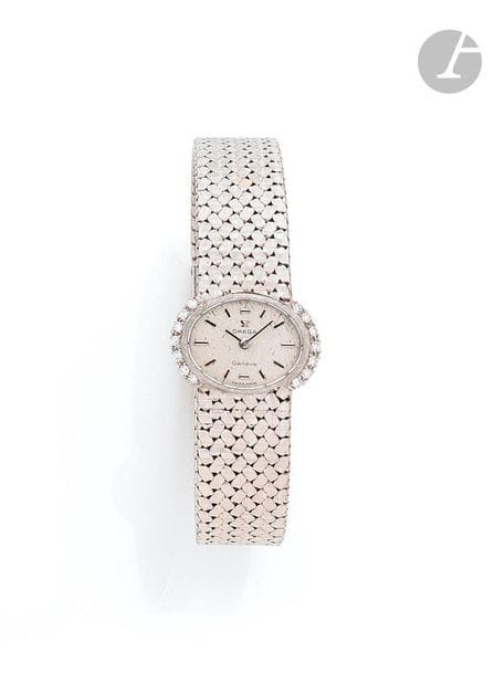 OMEGA. Circa 1970No. BC
8202Women's
wristwatch in
18K (750) white gold, bezel set with brilliant-cut diamonds, white dial, applied baton hour markers, mechanical-winding movement calibre 484, No. 26057356, integrated gold bracelet with
signature buckle. Signed

dial, case and movement

.


Length: 17.








5



cmRough











weight



: 50.4 g












