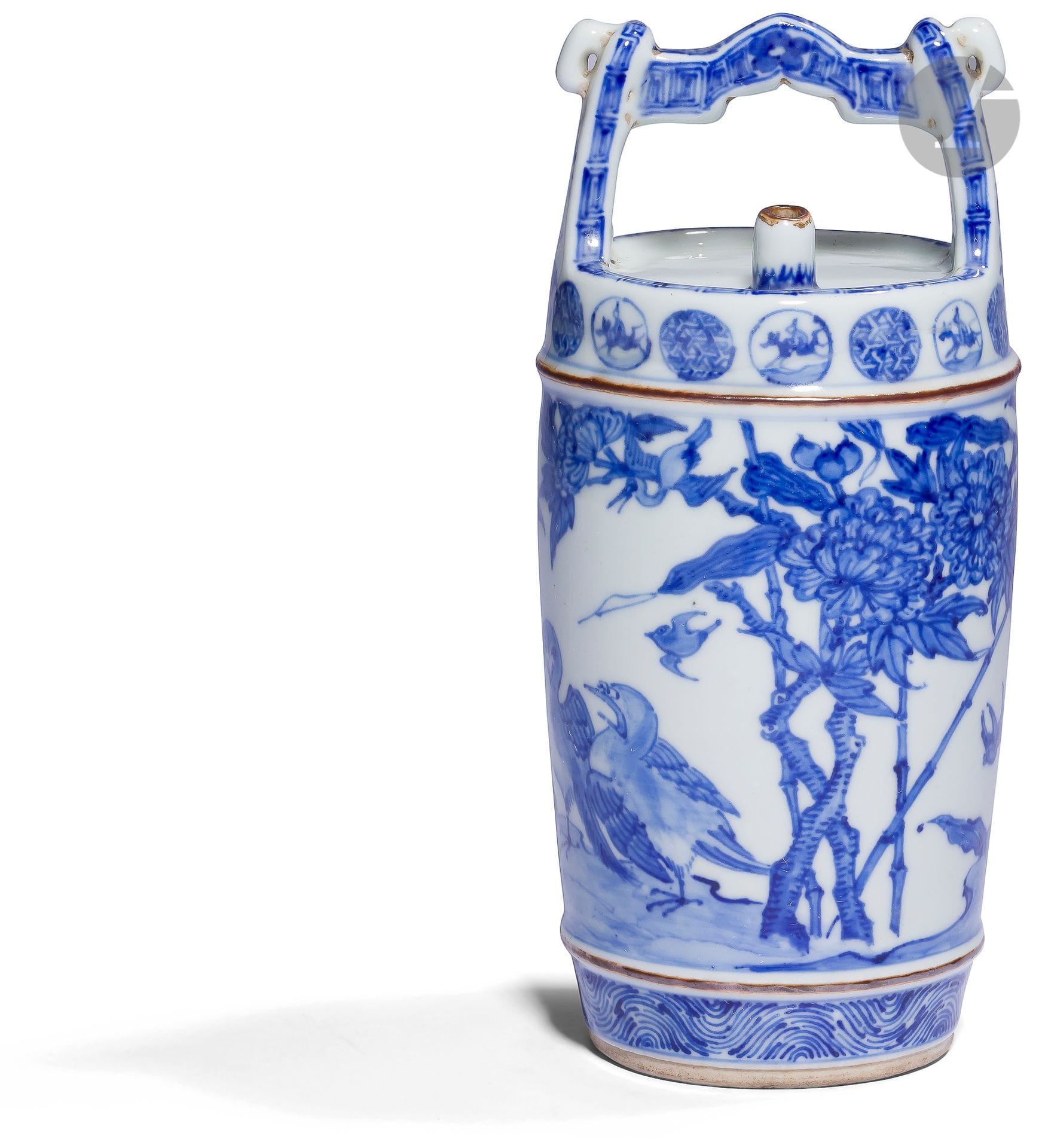 Small blue-white porcelain tokkuri, Japan, Arita kilns, late Edo period, 19th centurySmall
porcelain sake bottle in the shape of an oke (traditional Japanese bucket with handle). The body is decorated in blue underglaze with birds and floral motifs: bamboos, chrysanthemums and persicaria (or Japanese knotweed). The lower part shows a frieze of stylized waves and the upper part a frieze of medallions alternating with a rider and kumikikko (woven tortoiseshell) geometric motifs. The handle shows a classical decoration of Greek and foliage motifs. The heel is in unglazed biscuit.
Height : 20 cm

