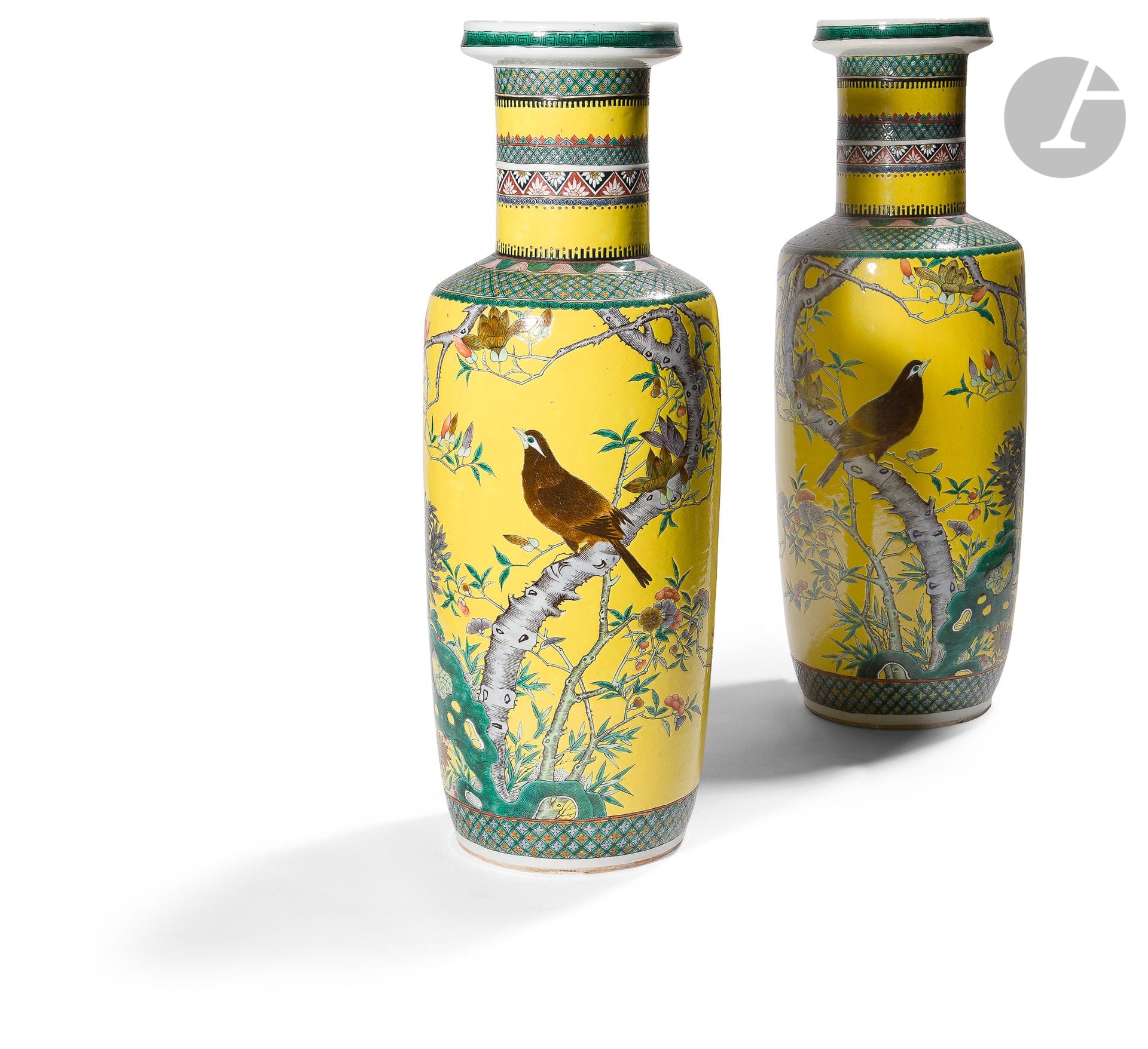 A pair of bangchuping or scroll porcelain vases with yellow enamel background, China, late 19th - early 20th centuryDecorated
in polychrome enamel with birds on flowering branches and rocks. The neck decorated with various friezes with geometric patterns, waves and stylized flowers. Apocryphal mark Kangxi with six characters in red on cover under the bases.
Height : 61 cm

