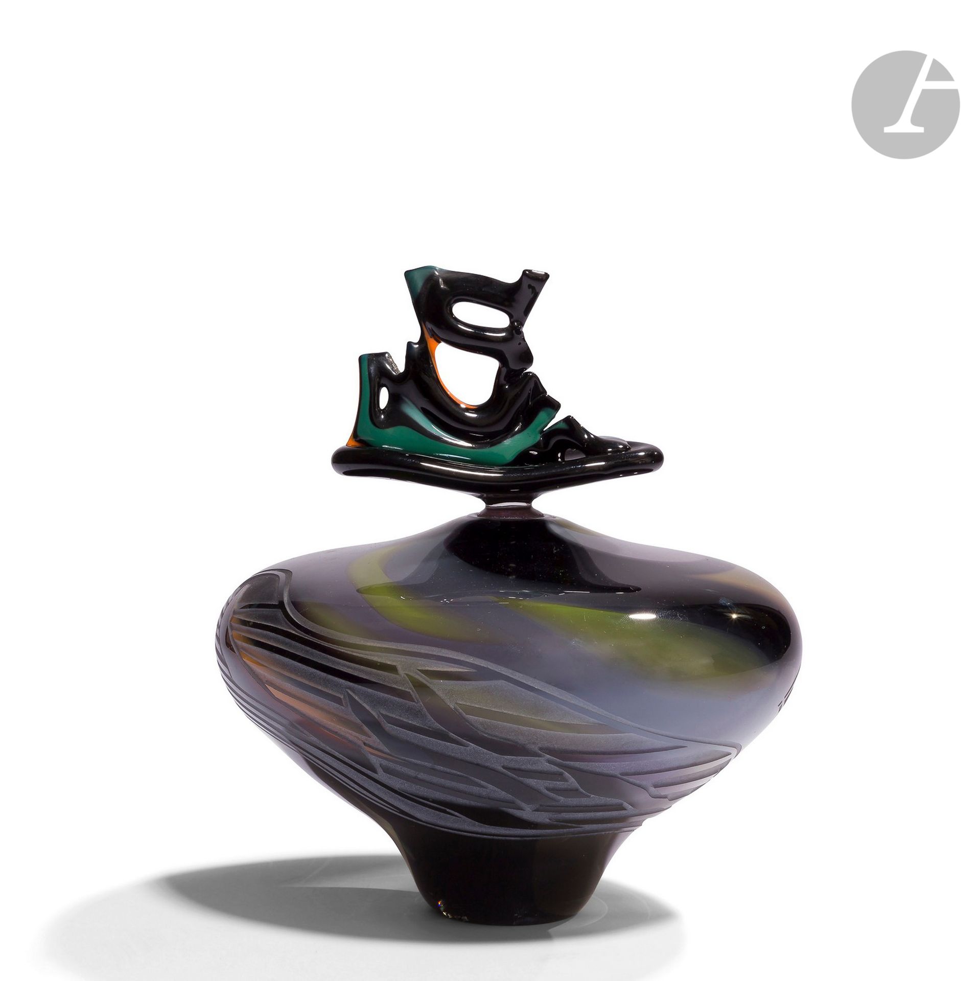 RéGIS ET GISÈLE FIEVET [French] (born in 1948 and 1951
)Blown glass bottle of toupie form, with polychrome intercalary decoration on black background, partially engraved with sand. Free-form coloured stopper. Signed and dated 1989 on the base.
H. 20 cm - D. 18 cmBibliography

:
Catalogue of the Contemporary Art Fair of Rouen, 1991 (reproduced).




