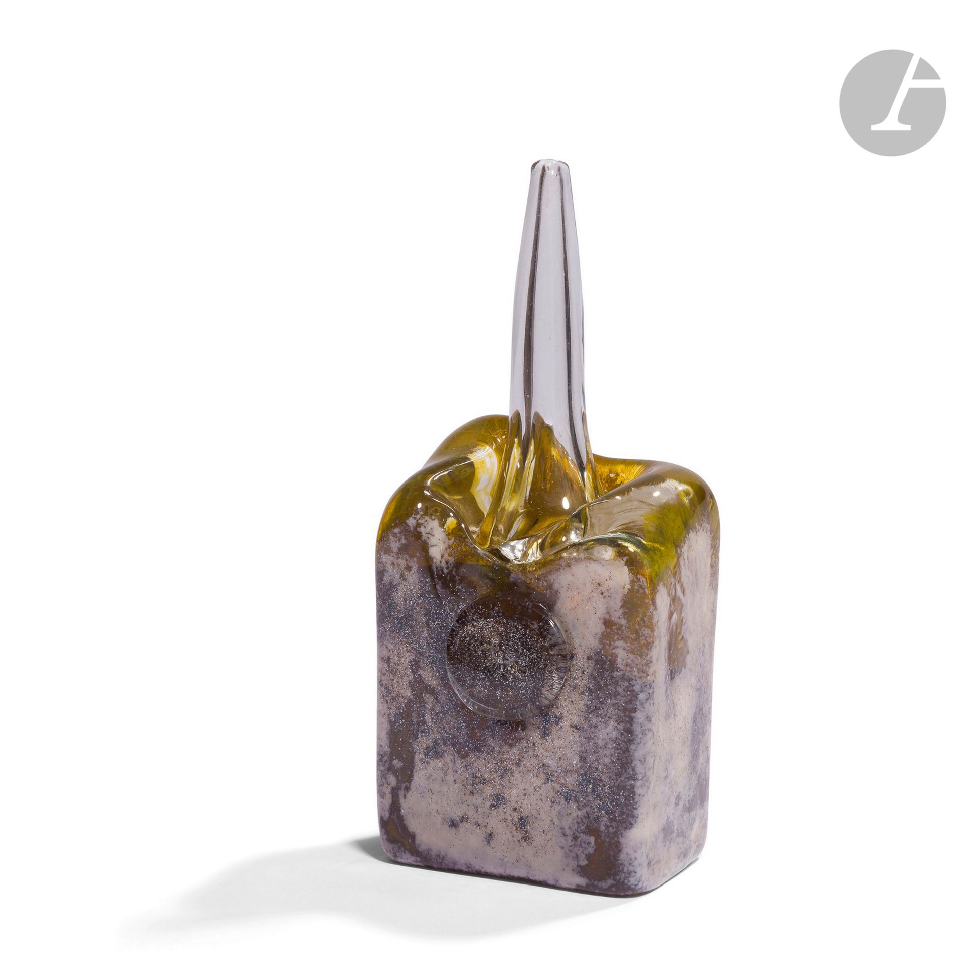 VERONIQUE LUTGEN [Belgian] (born 1962
) Small glass sculpture blown in a mould, yellow tinted, covered with metallic oxides. Signed and dated 1990 under the base.
H. 19 cm - W. 8 cm - D. 6 cm

