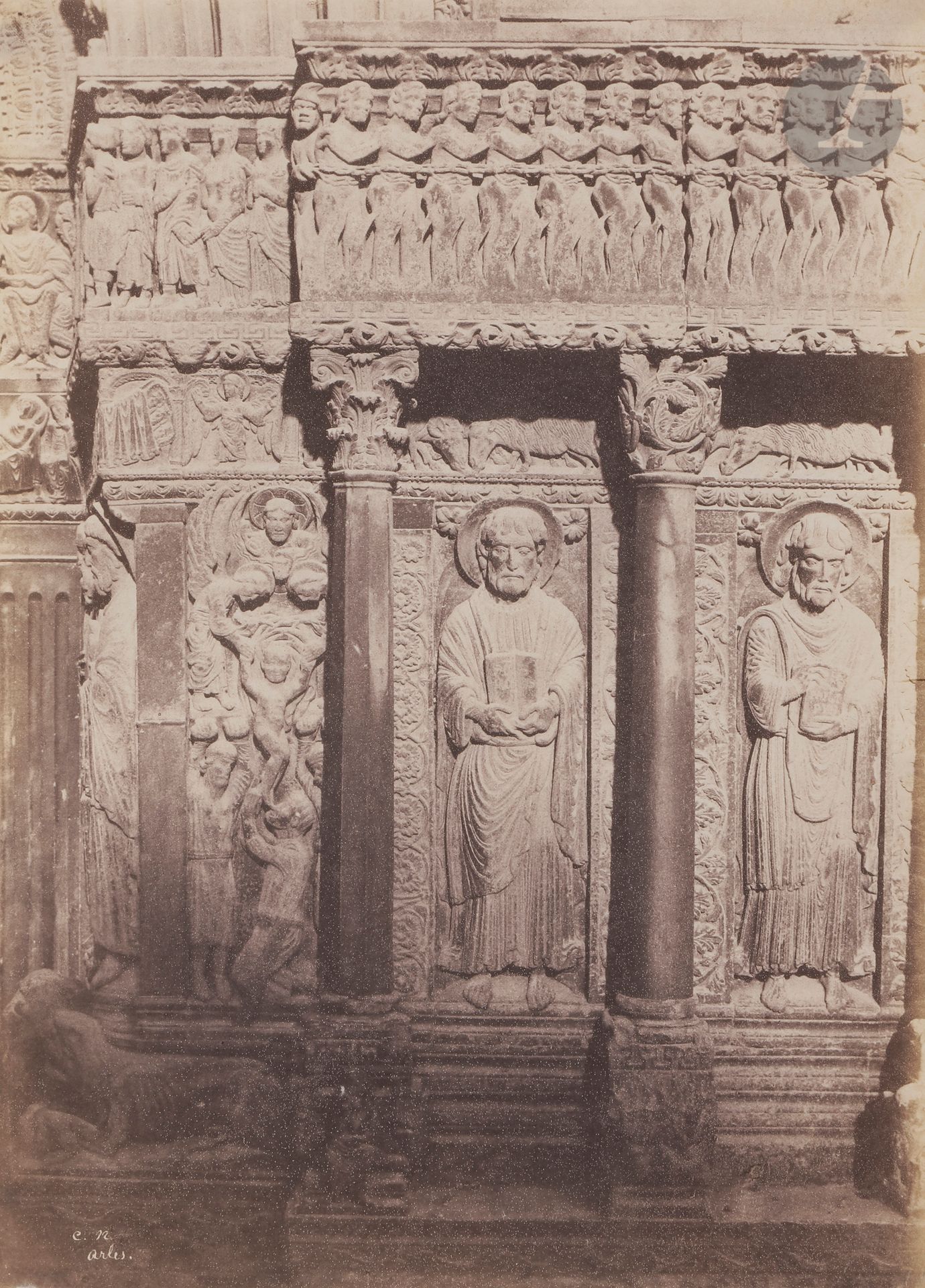 Charles Nègre (1820-1880) 
Portail de la cathédrale Saint-Trophime d’Arles, 1853.
Martyrs de Saint Étienne, Saint Jacques le Mineur et Saint Philippe.
Épreuve sur papier salé, d’après négatif papier, signée des initiales « C. N. » avec la légende « Arles » dans le négatif en bas à gauche. 
31,5 x 23 cm

Charles Nègre (1820-1880) 
Cathedral Saint-Trophime of Arles, 1853.
Martyrs of Saint Stephen, Saint James the Minor and Saint Philip.
Salt print, from paper negative. Initials "C. N." and caption "Arles" in the negative. 
31.5 x 23 cm