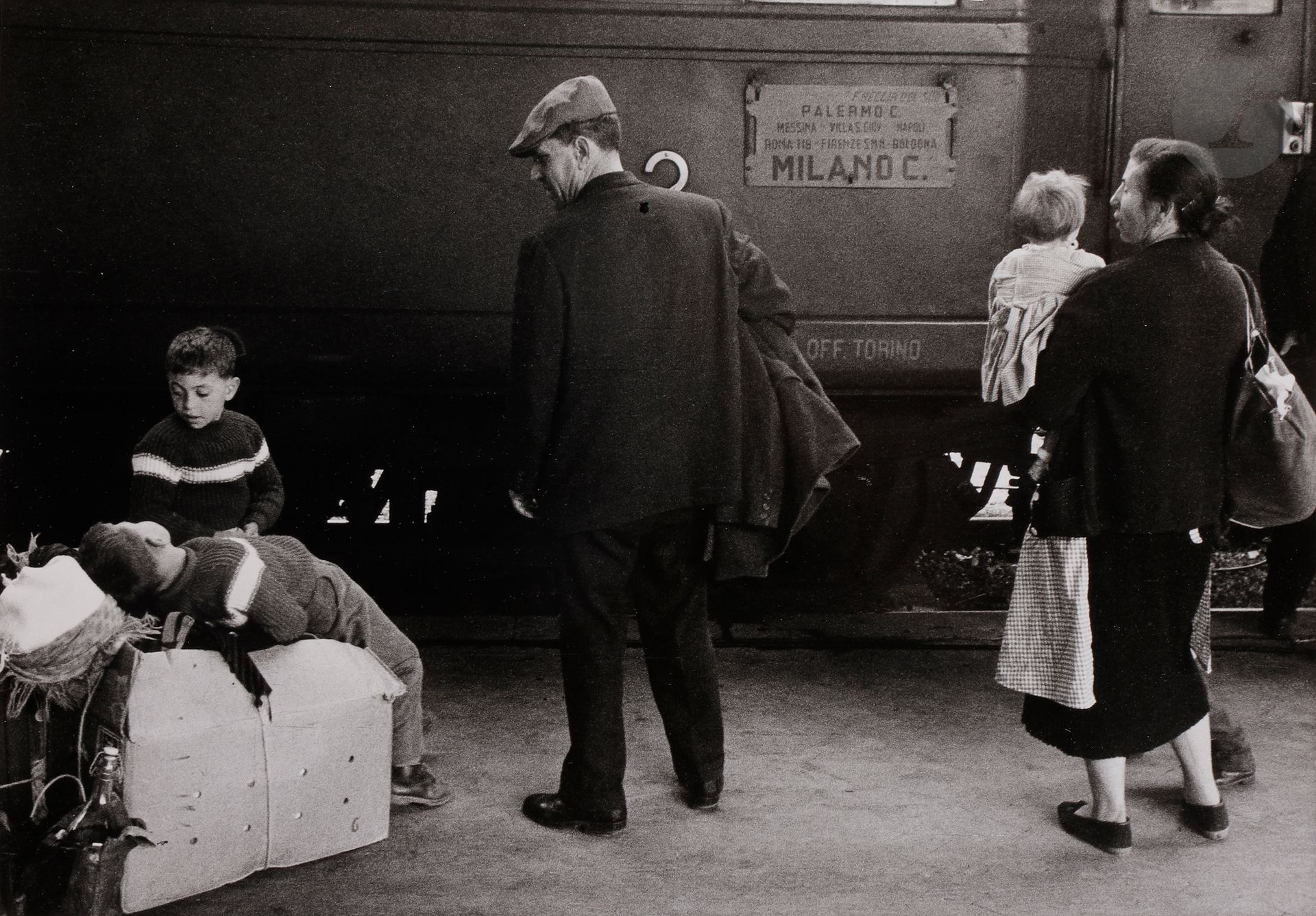 *Enzo Sellerio (1924-2012)
Migrants à la gare de Palerme, 1960. 
Épreuve argentique (tirage d’exposition,
c. 1990), signée avec le tampon « © Enzo Sellerio » au verso.
Image : 30,8 x 45,9 cm
Feuille : 39,7 x 49,7 cm

Enzo Sellerio (1924-2012)
Migrants at Palermo station, 1960. 
Gelatin silver print (exhibition print, c. 1990), signed and stamped "© Enzo Sellerio" on verso.
Image : 30.8 x 45.9 cm
Paper : 39.7 x 49.7 cm