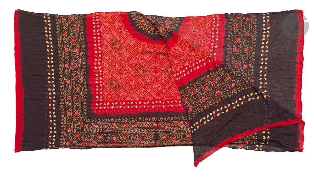 Large odhni shawl, India or Pakistan, 20th
centuryTrikit embossed cotton
cloth
with tie and dye print. Symmetrical composition of two rectangular panels separated by a red band. Each panel is decorated with a black half-medallion standing out on a red background decorated with small white and yellow dots drawing chevrons including elephants found in friezes all around.
90 x 380 cm 
Folds, fraying.

Provenance: 
Former Garabedian collection, Geneva
. 
 

A large Odhni cotton and tie dye shawl, India or Pakistan, 20th centuryProvenance

: Marie-Christine David Collection

.







