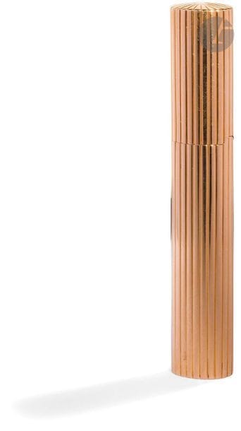 CARTIER Paris. Long briquet à essence en or jaune 750 0/00. Décor de cannelures verticales. Numéroté : 016400. H : 11.2 cm. Pb : 87.56 g