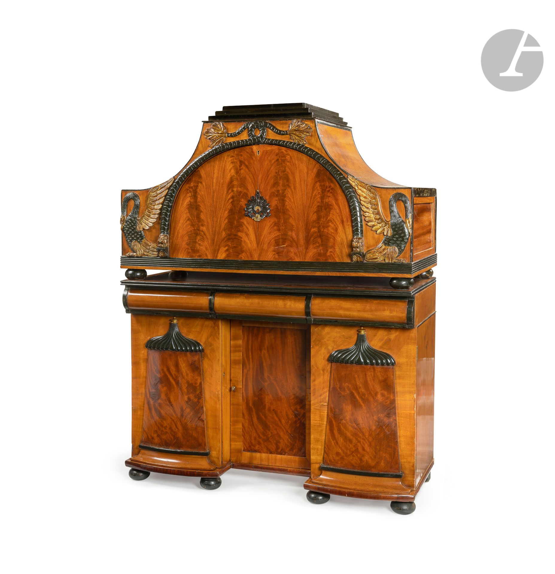Flamboyant mahogany, patinated wood and gilded wood flap desk, opening to a semi-circular flap with chimera and swan frame revealing three drawers and a mirror bottom, with two side compartments; resting on a base forming a desk opening with three drawers and three leaves; (probably composite). 
 Austria, Biedermeier period.
H: 157 cm, W: 121 cm, D: 55 cm