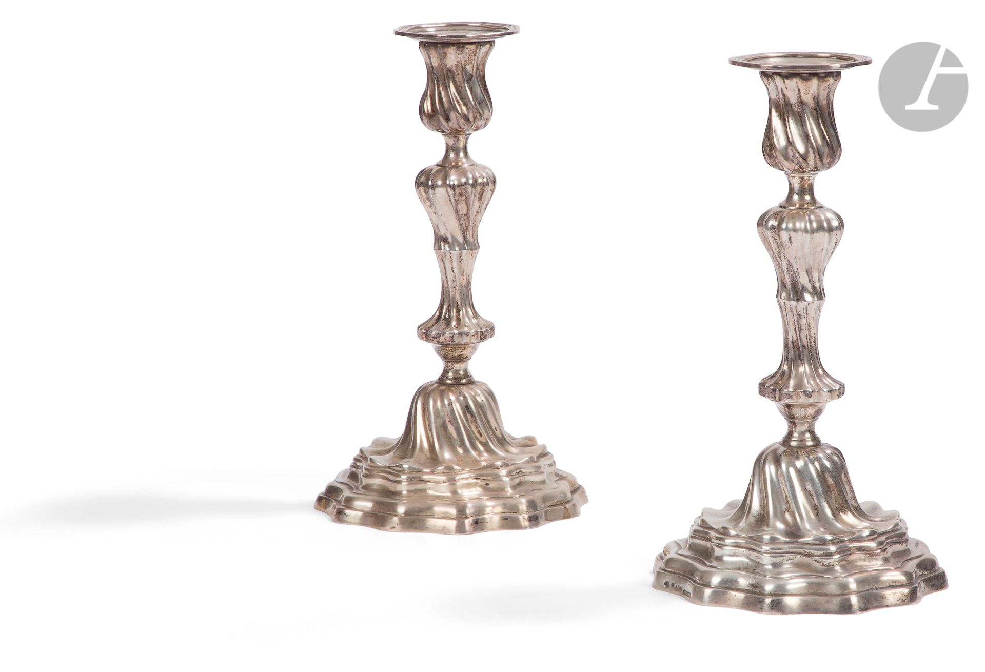 Pair of silvered bronze torches, the shaft in baluster with rocky mouldings decoration; (foreign punches). 
 19th century.
H: 26 cm