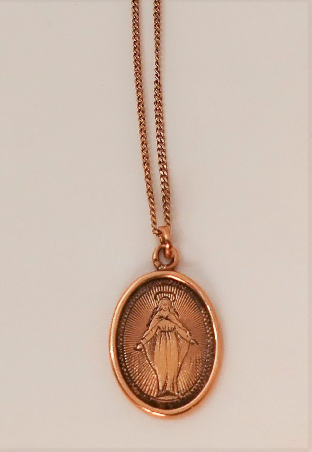 
Médaille mariale en or (18K) et bout de chaîne en or (18K) accidentée.

Poids : 3,2 g
