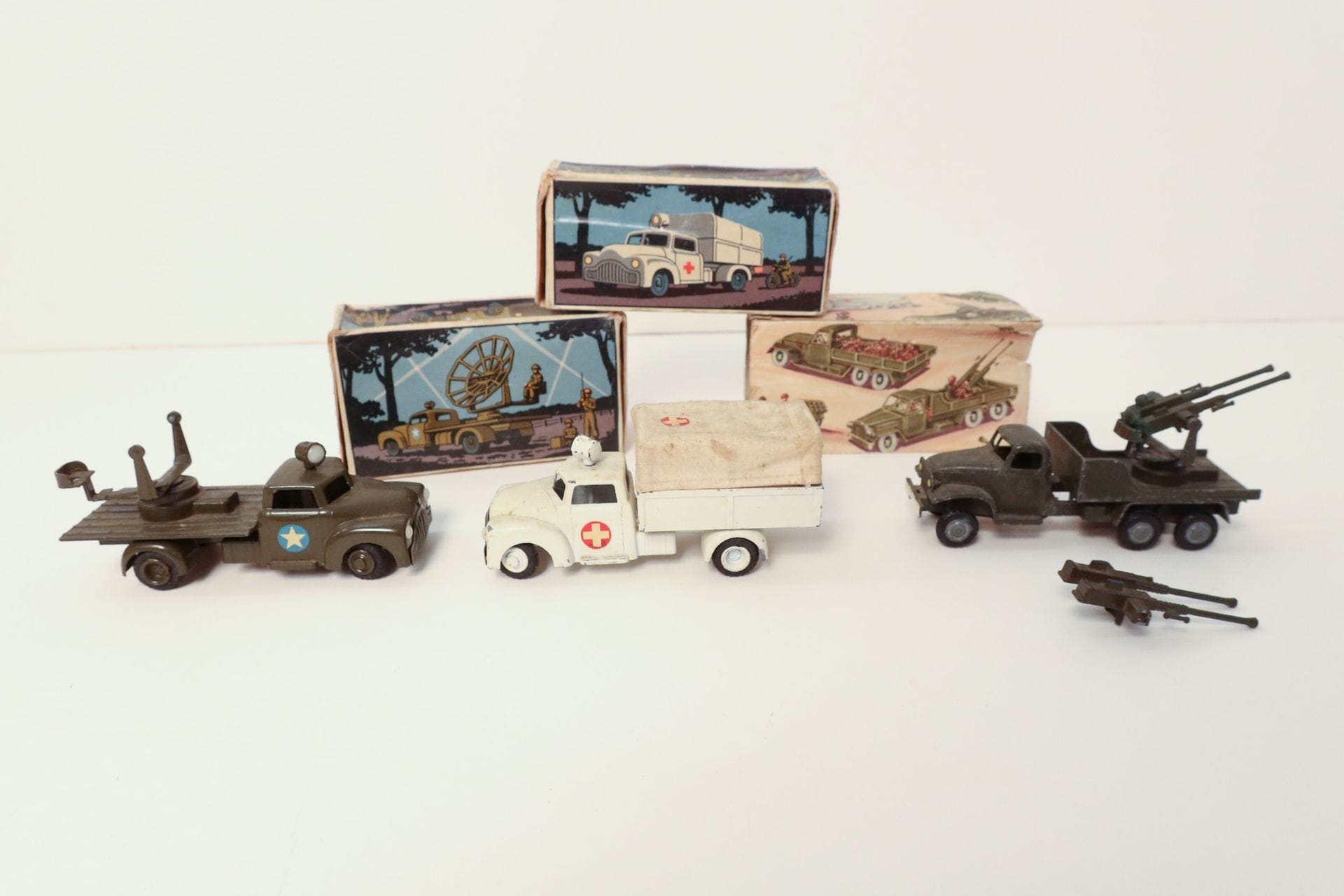 TEKNO 

Ensemble de 2 véhicules militaires : 

- Army truck anti-aircraft, ref. 953, avec boîte (bon état, personnage manquant), 

-  Ambulance med presenning, ref. 952, avec boîte (manques de peinture, rayures et usures). 

On y joint : une miniature Truck anti-aircraft, avec boîte (boîte déchirée, manques de peinture)