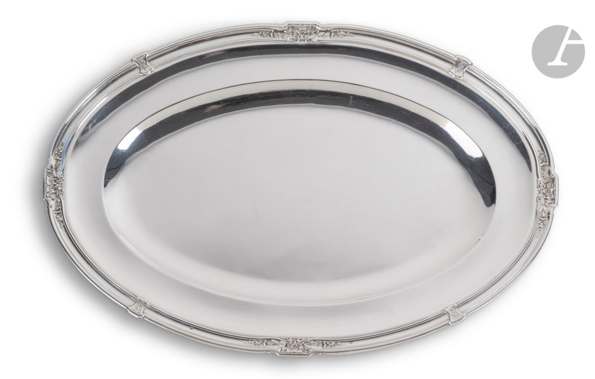 FRANCE XXe SIÈCLE
Plat en argent de forme ovale mouluré de filets et rehaussé de quatre motifs floraux encadrés de nœuds de rubans et de quatre gaines .
Poinçon minerve
Orfèvre : RAVINET D’ENFERT
Poids : 1291 g - longueur : 45 cm - largeur : 31 cm