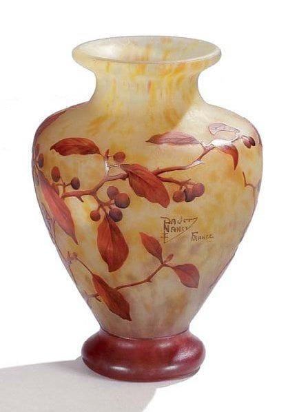 DAUM Nancy France
Vase balustre. Épreuve en verre multicouche dégagé à l'acide au décor tournant émaillé rouge, de baies branchées et feuillagées, sur fond jaune et blanc marmoréen. Signature écusson émaillée. Hauteur: 25 cm