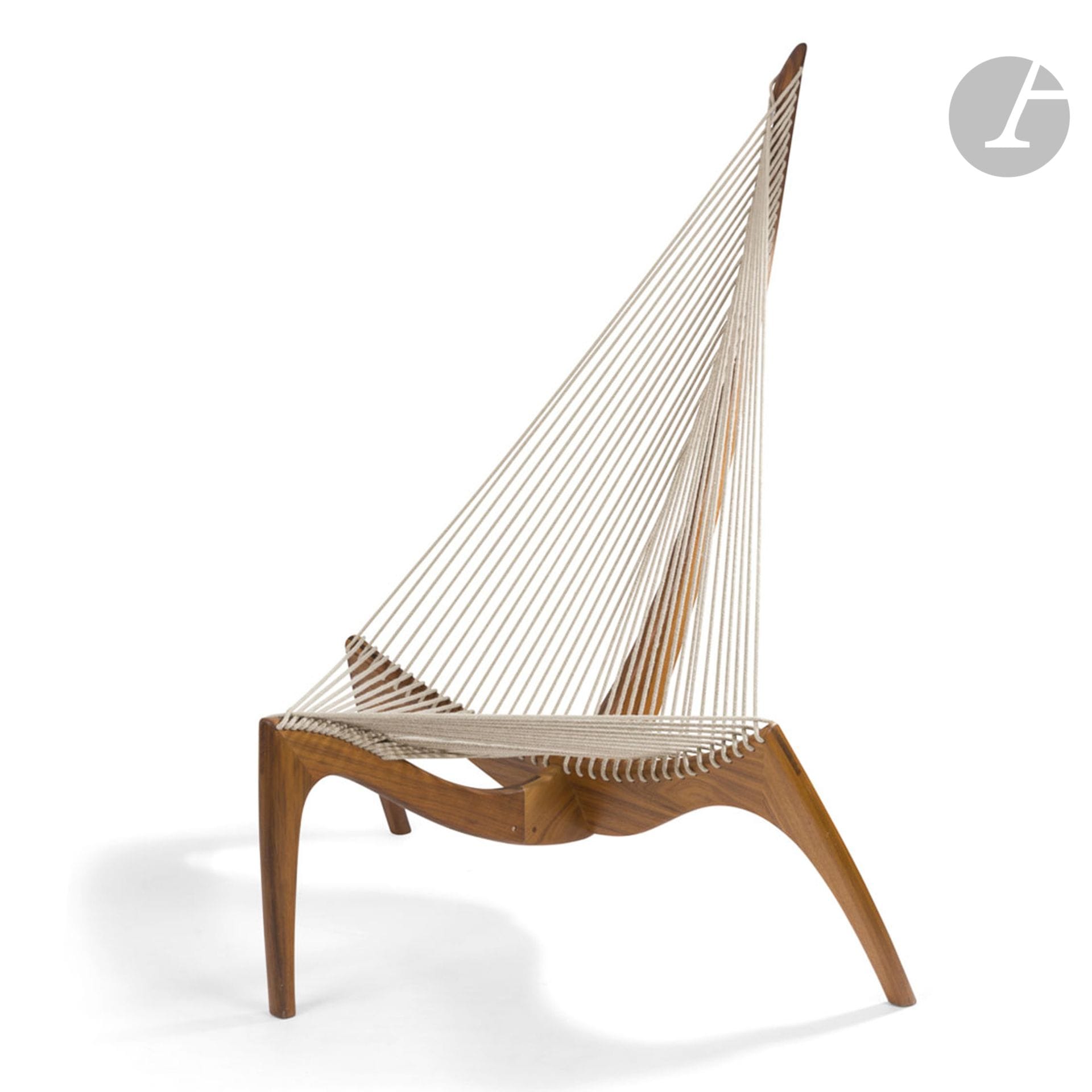 Jørgen HØVELSKOV (1935-2005) & KOCH DESIGNThe
Harp Chair, the model designed in [1963]
Armchair sculpture. The tripod teak base extends into a mast; holding the taut ropes forming the seat. Publisher's plate on the back of the base. H. 138 cm - W. 108 cm - D. 73 cm

