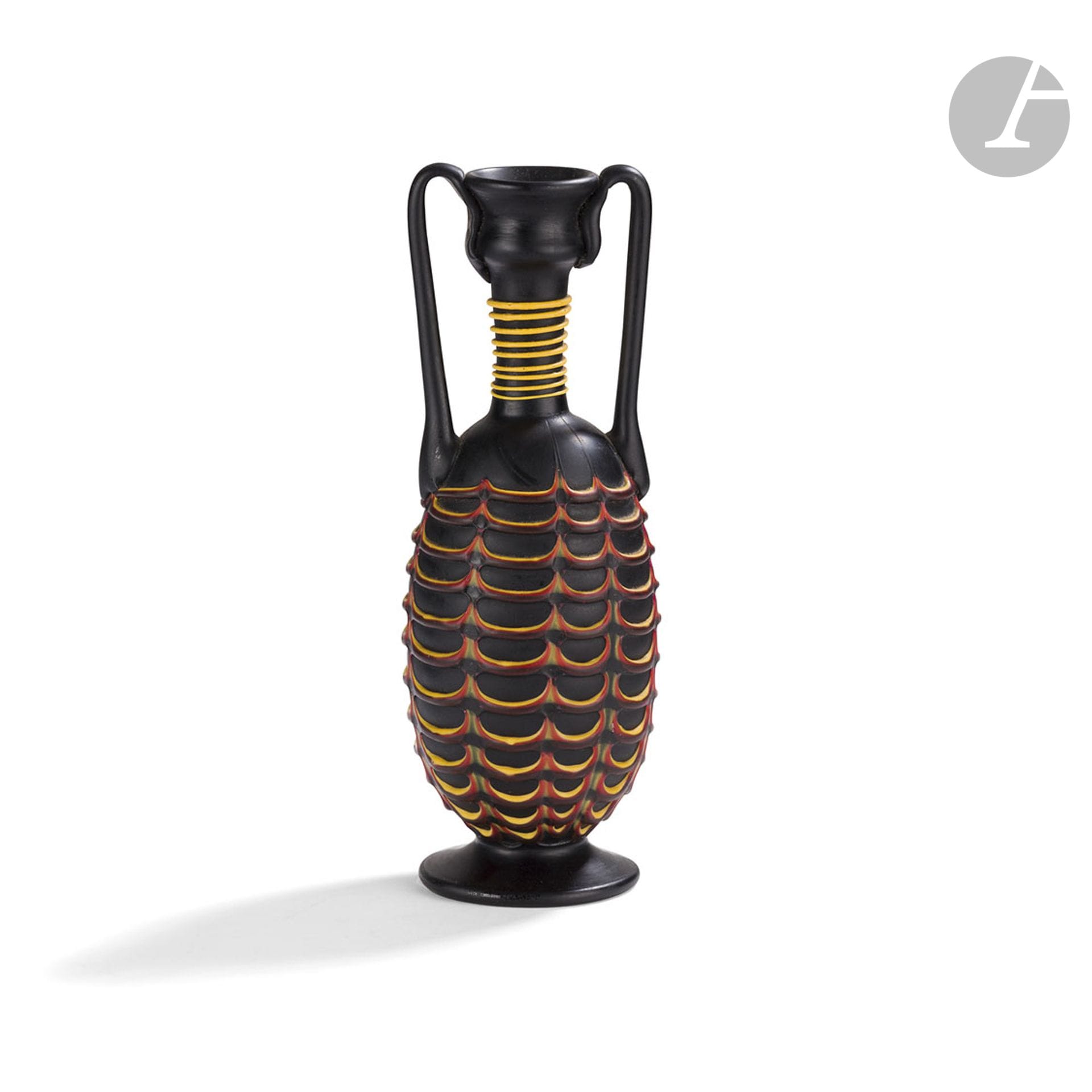 FRATELLI TOSO IN MURANOFenicioSmall

amphora vase with two hot-applied handles. Proof in matt black glass with hot-applied decoration of a yellow and red net on the body and a yellow net on the neck. Small chips at the top of the handles. Antique label Meubles d'art Majorelle Paris Nancy Lyon annotated 1925 in ink, under the base. H. 17,5 cm

