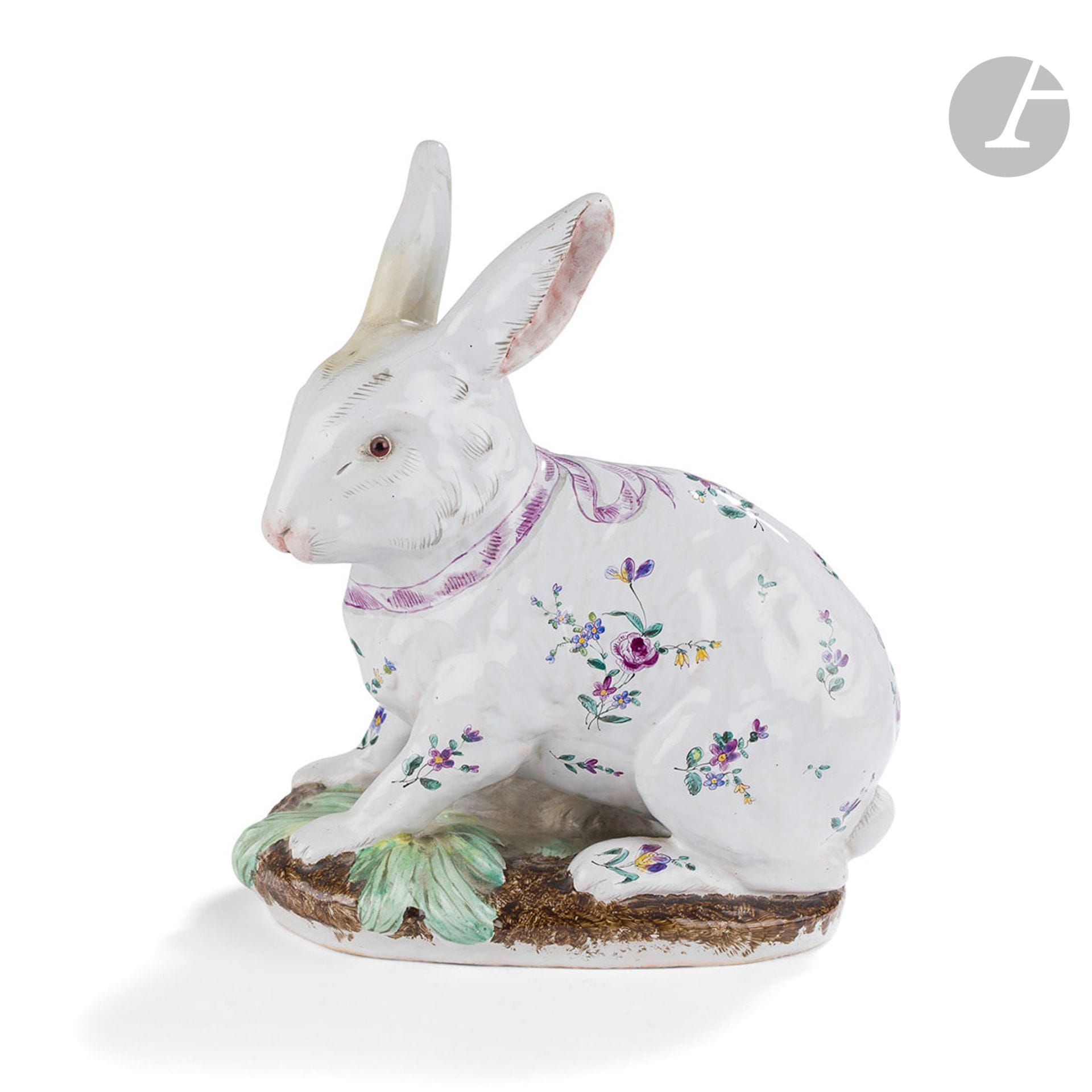 ÉMILE GALLÉ (1846-1904) & CHARLES GALLÉ-REINEMER (1818-1902) 
Lapin assis
Bouquetière zoomorphe. Épreuve en faïence (terre de Lorraine) émaillée polychrome. Le corps du sujet au décor de bouquets ; les yeux en sulfure. Une oreille cassée recollée et restaurée. Signé GALLÉ Nancy et marqué Tr Lor Saint-Clément, sous la base. H. 20 cm – L. 18 cm – P. 11 cm