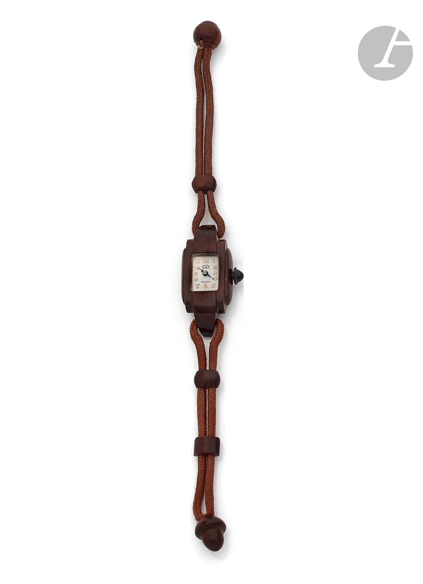 VAN CLEEF & ARPELS. Circa 1930

Steel and wood ladies' wristwatch, white dial, Arabic numeral hour markers, mechanical movement, leather cord bracelet and wooden attachments. Dial signed. Dimensions: 17 mm x 39 mm