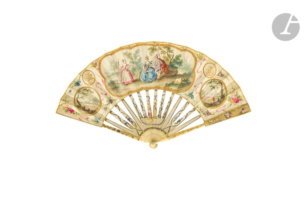 The Shepherd Musicians, Europe, ca. 1770-1780
Folded fan, the leaf in skin, mounted in English, and painted in gouache with five cartels. Two with animated landscapes, and two painted with baskets of fruit in bistre monochrome. In the center, two shepherds near a grove play some musical notes.
Three roses painted on the reverse side.
Ivory frame* finely cut and carved with country trophies, and a couple and his dog enhanced in colors. A couple on the plumes. 
H.t. 27 cm-H.f. 12,1 cm (wear, restorations) 
Gross weight : 56 g