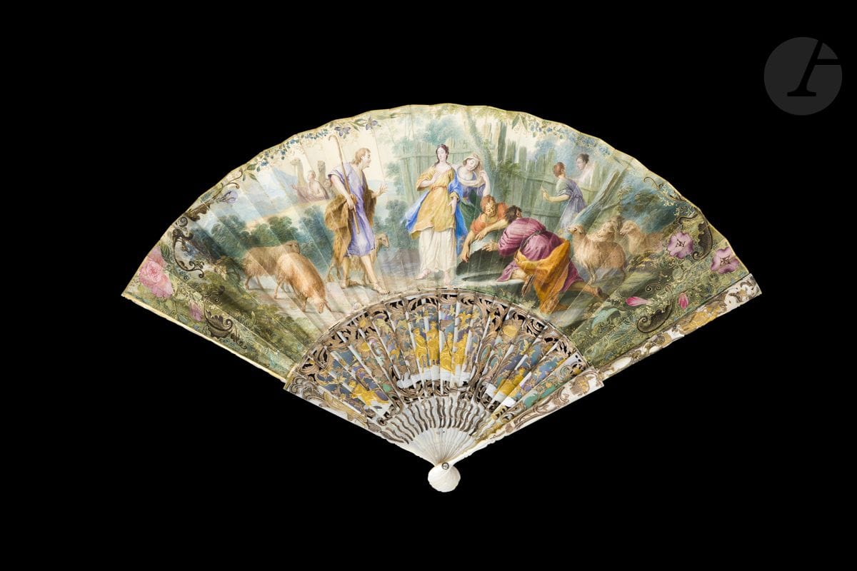 Eliezer et Rebecca, Europe, vers 1740-1750
Éventail plié, la feuille en peau, montée à l’anglaise et peinte à la gouache d’un berger parmi ses moutons s’adressant à deux jeunes femmes près d’un puits. Deux hommes soulèvent le couvercle pour permettre aux animaux de s’abreuver. Des chameaux apparaissent à l’arrière-plan.
Revers peint d’un homme guidé par une paysanne.
Monture en nacre blanche découpée, sculptée, gravée, burgautée et dorée de berger et bergère, et d’un sujet galant au centre. 
H.t. 28,5 cm-H.f. 14 cm (usures, restaurations)