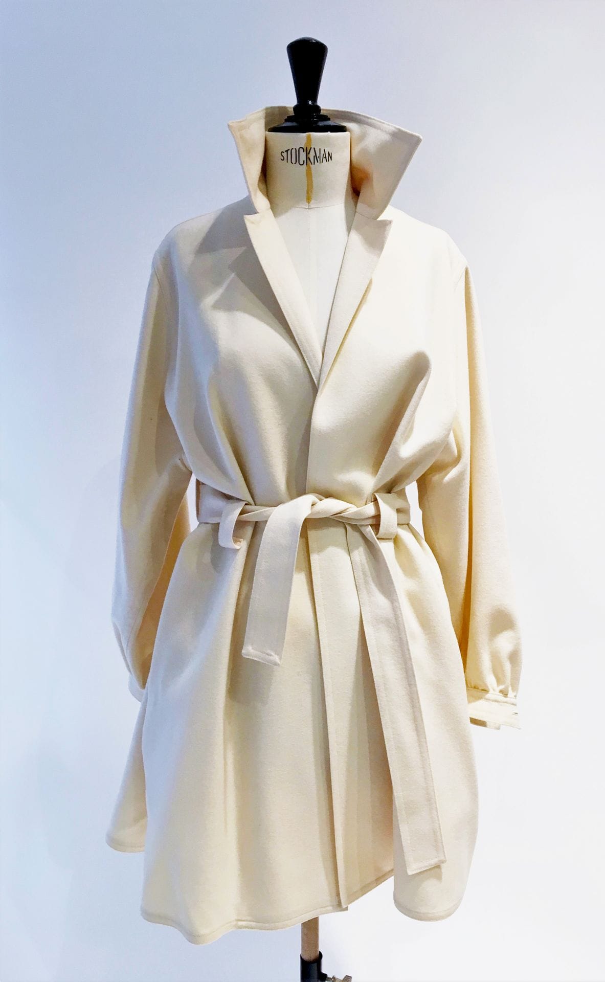 Jean-Louis SCHERRER. N°001681. Short coat in ivory wool with belt, slight trace on the sleeve. S.38 approx.