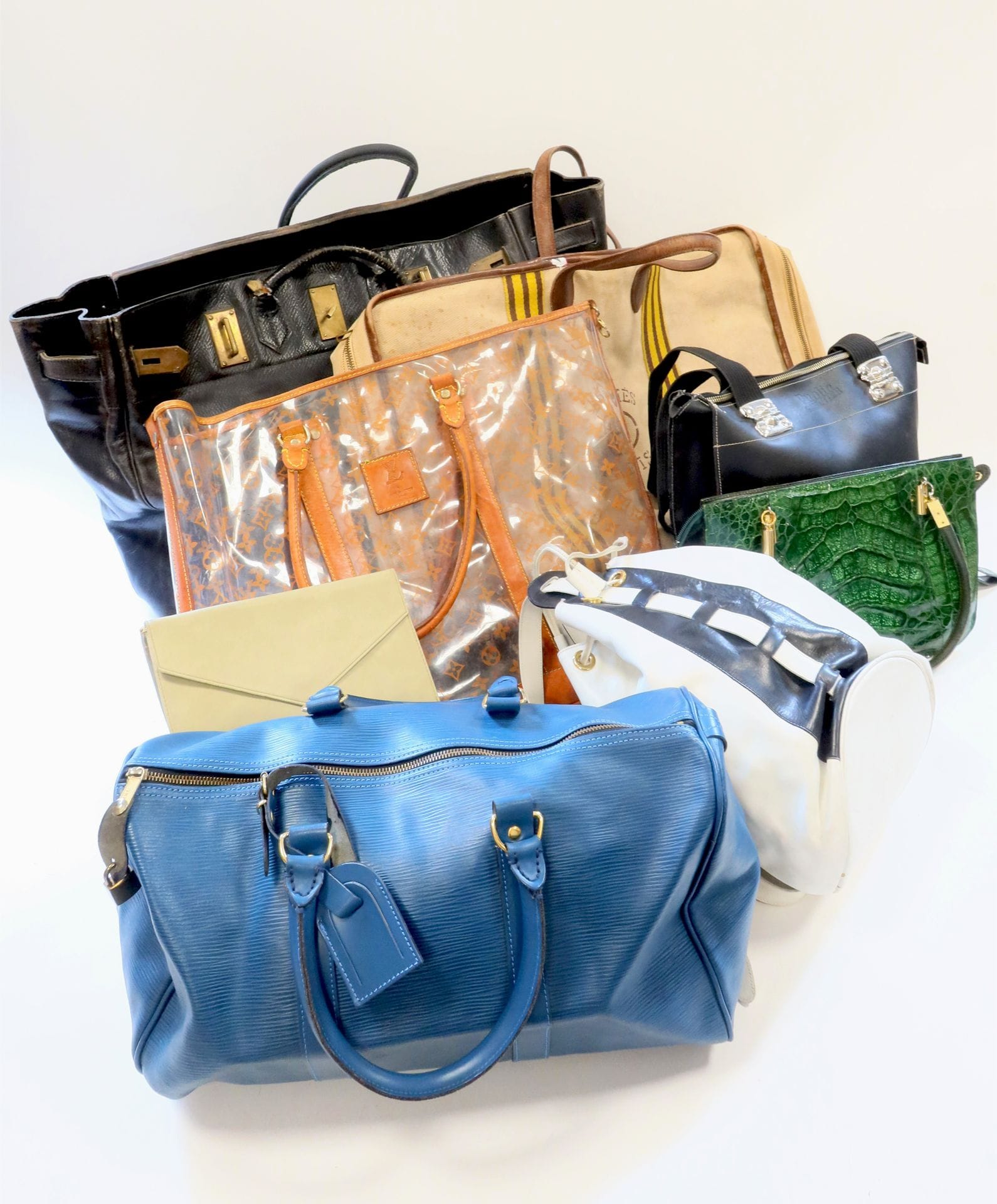 HERMÈS Paris et HERMÈS Paris Made in France. Lot de deux grands sacs, un haut à courroie en cuir grainé noir très accidenté et modifié, l'autre en toile et cuir (taches importantes et grosses usures au cuir)