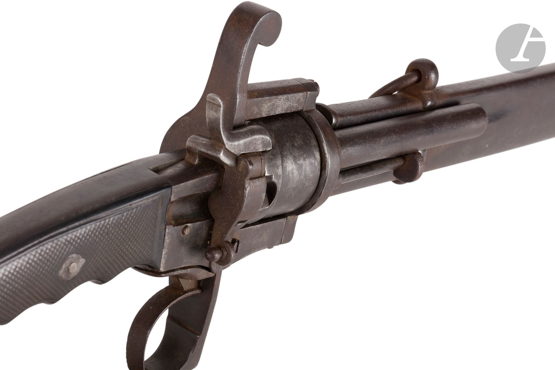 Sabre revolver with pin, six shots, calibre 7 mm
Iron
frame.
Handle with plates of squared blackened wood stick. Guard with a branch. Round barrel. Cylinder plain. Hound with flat cheeks. Iron ramrod. Curved blade with counter-edge, hollow sides and gutter, finely engraved in the third of foliage and trophies. Iron scabbard with two bracelets and two rings. Iron sting.
Length : 102 cmB
.E. Patinated. Italy. Circa 1860-1870.


This officer's revolver sword is sometimes called "model 1864"


.


It would have been developed by the Milanese harquebusier Carlo Maria Colombo in 1864, by adding a pinfire revolver on an Italian officer's saber model 1855.

It should be noted that this model was also produced by Liège and French harquebusiers.









