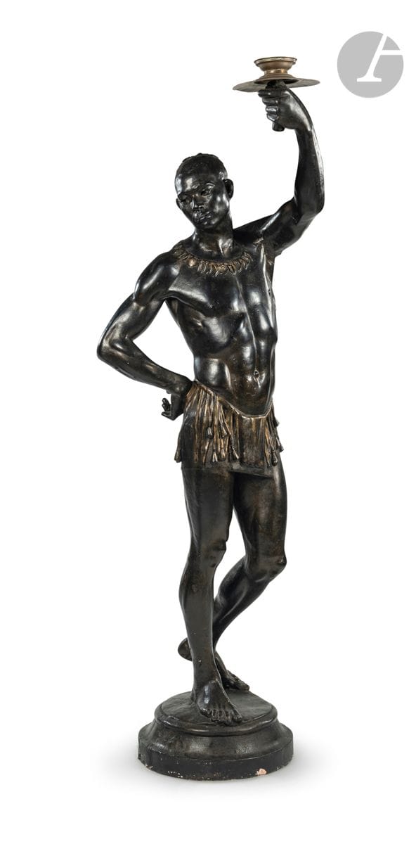 Nubien porte-torchère en plâtre patiné ; (accidents).
XXe siècle.
H : 205 cm