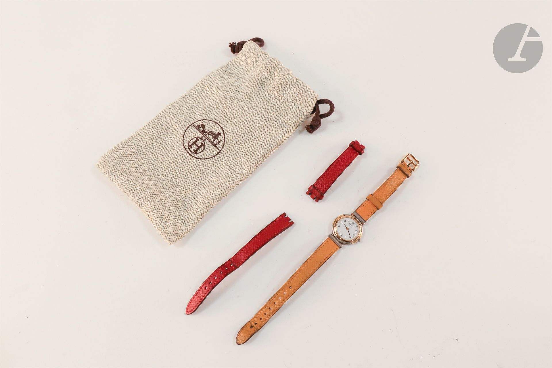HERMES vers 1990.

Montre bracelet pour femme en métal doré et acier, cadran blanc, mouvement à quartz (pile non vérifiée), bracelet cuir avec sa boucle ardillon signée.
