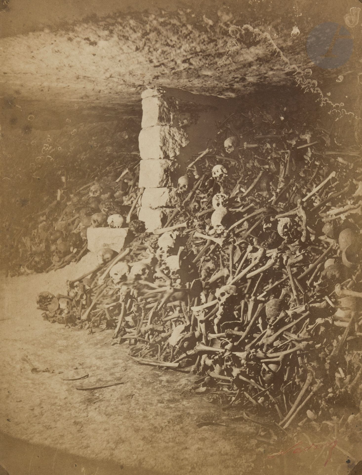 Félix Nadar (1820-1910)
Les catacombes de Paris, c. 1861-1864.
Crypte n°1. Crypte n°7. Façade n°5.
Un bourrage. Ossements du cimetière de Vaugirard. “Sicut Unda, Dies Nostri Fluxerunt” (Comme l’onde, nos jours se sont écoulés).
Trois (3) épreuves sur papier albuminé, contrecollées sur cartons. Tampon-signature (1) « Nadar » à l’encre rouge en bas à droite. Légende manuscrite à l’encre sur le montage en bas (1).
22,6 x 19 ; 23,3 x 18 ; 26,8 x 20,5 cm

Bibliographie :
 - Philippe Néagu et divers, Le Paris souterrain de Félix Nadar 1861 : des os et des eaux, Paris, C.N.M.H.S., 1982, pp. 30, 31, 34, ill. 34, 37, 42.
 - Sylvie Aubenas, Catacombes. Nadar au royaume des morts, L’Œil Curieux, Paris, 2018, pp. 10, 37, 39.


Félix Nadar (1820-1910)
The catacombs of Paris, c. 1861-1864.
Crypt n°1. Crypt n°7. Facade n°5.
A stuffing. Bones from the Vaugirard cemetery. "Sicut Unda, Dies Nostri Fluxerunt" (Like the wave, our days have passed).
Three albumen prints, mounted on cardboard. Signature stamp (1) "Nadar" in red ink on the lower right corner. Handwritten caption in ink on the mount at the bottom (1).
22,6 x 19 ; 23,3 x 18 ; 26,8 x 20,5 cm