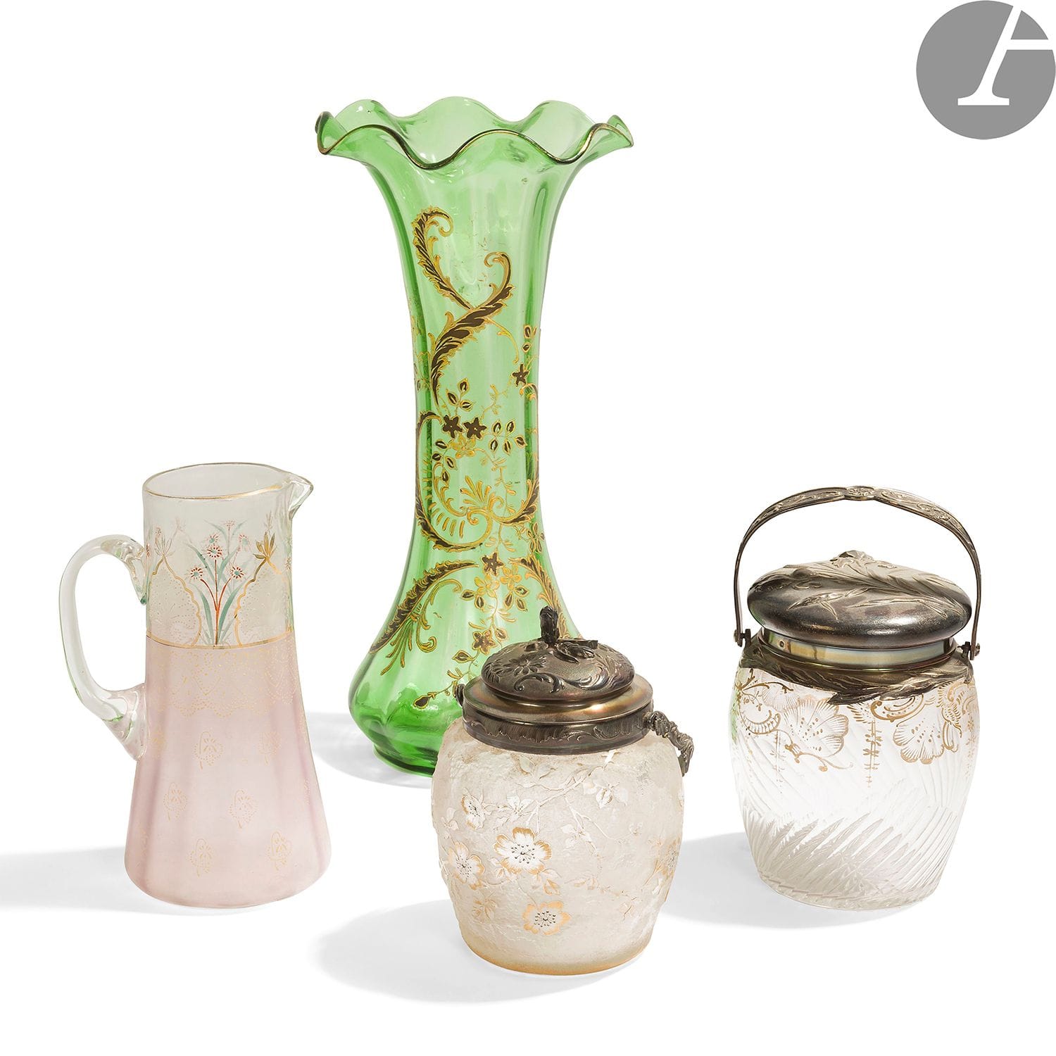 TRAVAIL ART NOUVEAU - COLLECTION GEORGES TERZIAN
Lot de verreries comprenant : 
- 2 pots à biscuits en verre, l'un gravé à l'acide de fleurs, l'autre à décor émaillé de palmettes, les montures en argent (poinçons de garantie). H. 17 cm et 20 cm. Poids brut : 1987 g
- Grande vase tronconique au col corolle en verre teinté vert à décor émaillé et à l'or de rinceaux. H. 40 cm
- Pichet en verre à décor émaillé polychrome et à l'or de fleurs. H. 22 cm